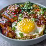 A vibrant Tofu Jammy Egg Breakfast Bowl with fluffy rice, golden tofu, and a halved jammy egg.