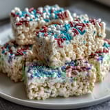 Red, white, and blue Rice Krispies treats with vibrant layers, perfect for patriotic celebrations and summer gatherings.