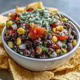 Colorful cowboy caviar dip featuring black beans, sweet corn, and zesty pico de gallo ready to serve.  