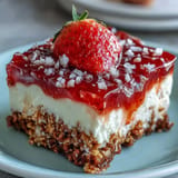 Juicy strawberry pretzel salad dessert glistening with sweet, salty, and creamy goodness.
