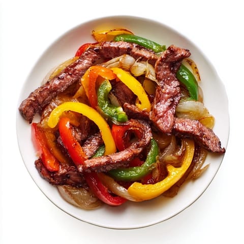 A vibrant photo: tender steak fajitas with fresh cilantro, a flavorful Mexican meal.