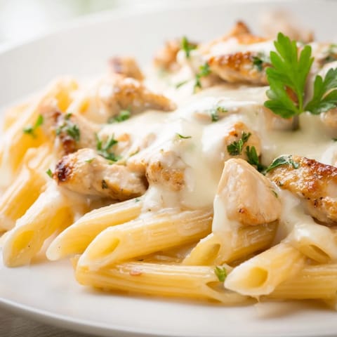 This Chicken Alfredo Bake's creamy sauce coats the pasta, topped with melted mozzarella and parmesan.