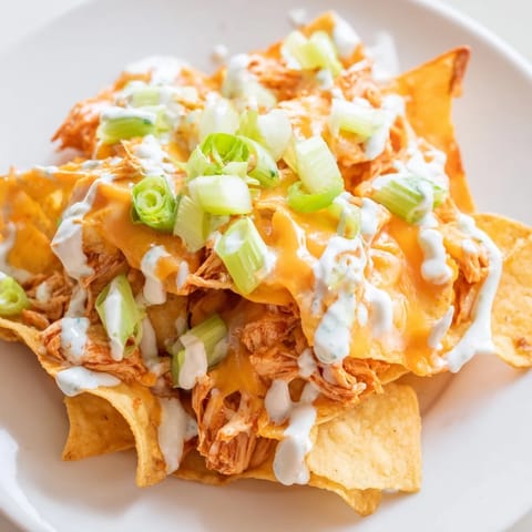 Spicy buffalo chicken piled high on crispy tortilla chips, finished with diced celery and cilantro.