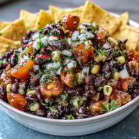 Vibrant 3-ingredient cowboy caviar dip with black beans, corn, and pico de gallo in a serving bowl.  