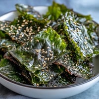 Crispy seaweed snack chips with sesame and salt, a healthy baked savory treat.